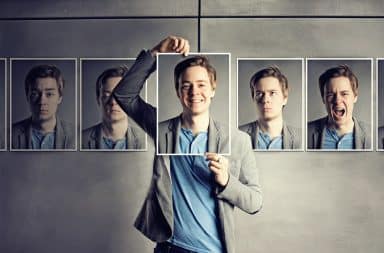 Man holding up his own photos