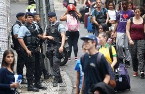 Nervous American tourists in Brazil near police with rifles