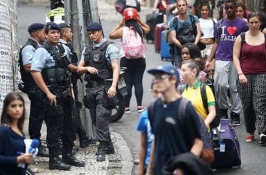 Nervous American tourists in Brazil near police with rifles