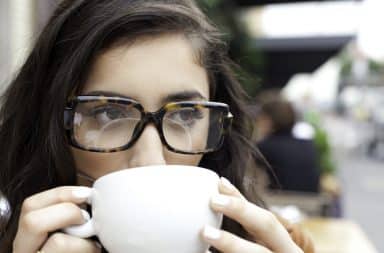 Woman wearing men's eyeglasses