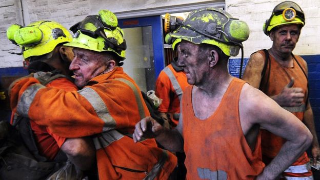 Coal miners hugging