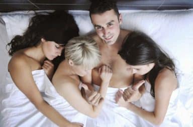 Husband with three wives in bed