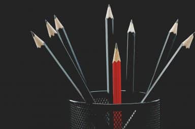 Red pencil within black pencils
