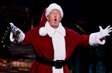 Donald Trump in a Santa outfit on stage