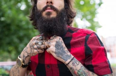 Hipster guy with a beard and tattoos