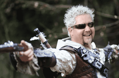 Guy Fieri holding guns