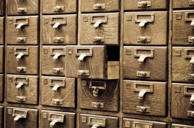 Vintage wooden card catalog drawers with brass handles