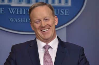 Sean Spicer laughing at podium