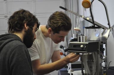 Coffee machine inspection by two men