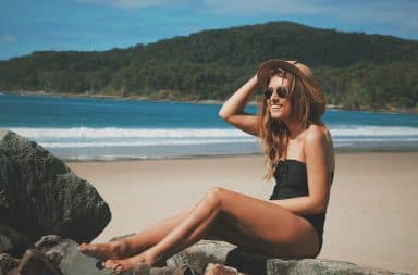 Girl traveling the world on a beach