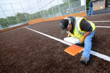 Man doing maintenance on third base