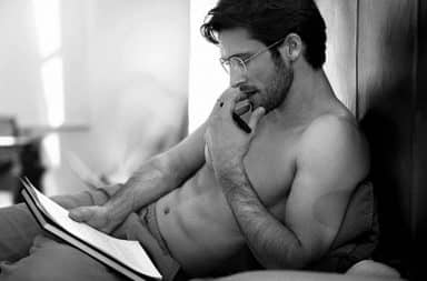 Man reading sexy in bed