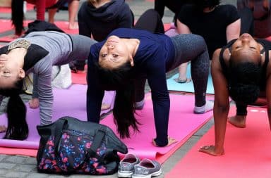 Women doing backwards pose in yoga class