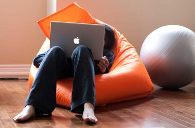 Sitting at a laptop in a bean bag chair