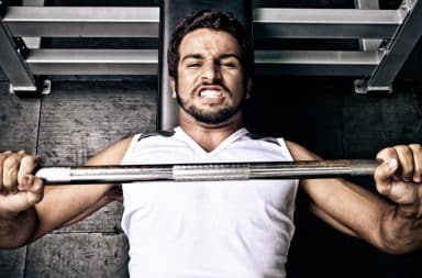 Man doing bench press at the gym