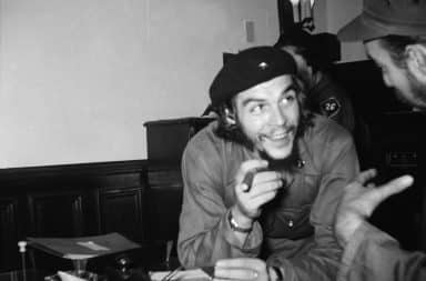 Che Guevara in Cuba smiling holding a cigar