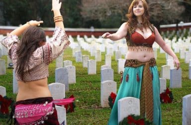 Women belly dancing on graves