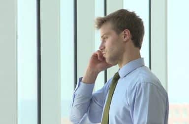 Man on cell phone in his office