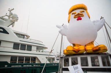 Trump inflatable chicken next to yacht