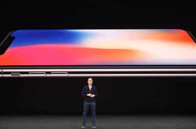 Apple CEO Tim Cook on stage presenting future iPhone