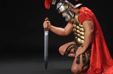 Gladiator kneeling down with a sword