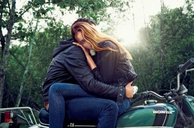 Woman hugging a man on a motorcycle