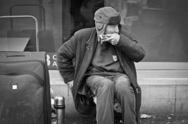 Guy playing the harmonica on the street