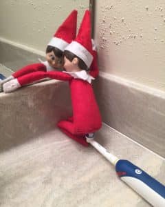 Elf on a Shelf by the toothbrushes