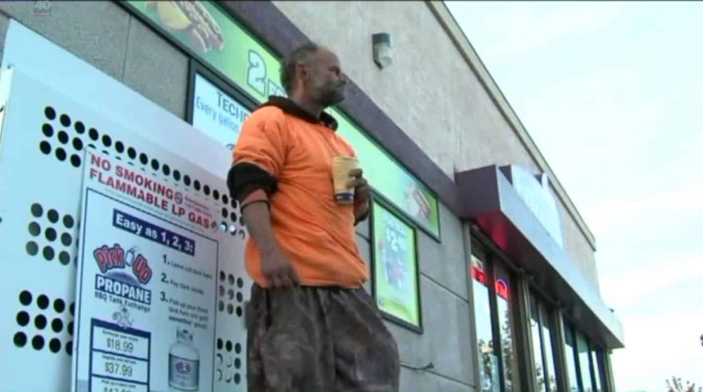 Homeless man outside a gas station