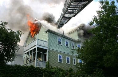 Fire ladder from fire truck reaches house on fire