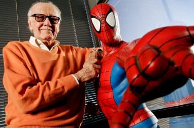 Stan Lee standing with Spiderman