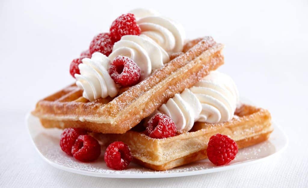 Raspberry waffles with whipped cream