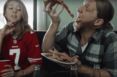 Woman watching the Super Bowl with her boyfriend