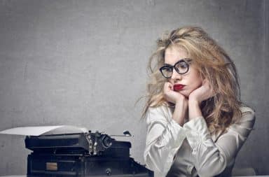 Woman with writer's block at a typewriter