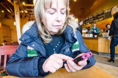 Mom texting in a coffee shop