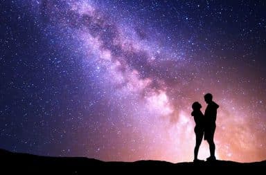 Couple basking in the glow of a night sky