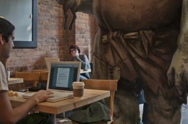 Giant in a coffee shop, using all the wifi