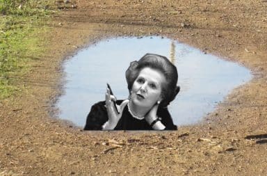 Margaret Thatcher's reflection in a rain puddle