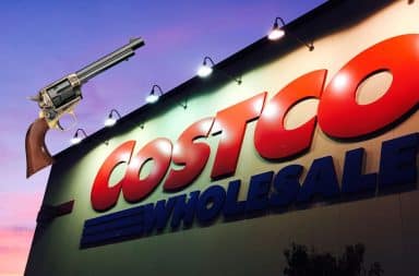 Costco Wholesale sign at night with a gun on it