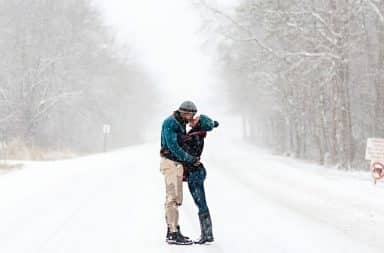 snowy couple risking getting hit by a plow, honestly, get out of the road!