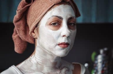 Woman with a white face mask for dry skin