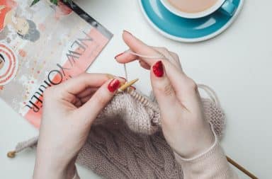 New Yorker magazine on table with woman's hands and coffee