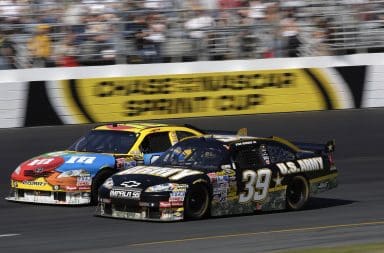 Two NASCAR race cars on an oval track