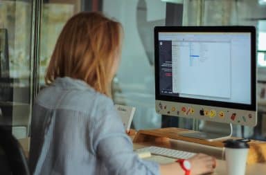 Woman at a desktop keyboard