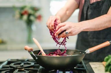 Man cooking in a pan on a stovetop burner