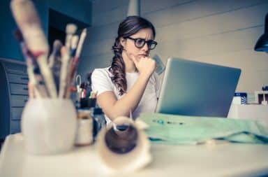 Woman reading BuzzFeed quiz on laptop