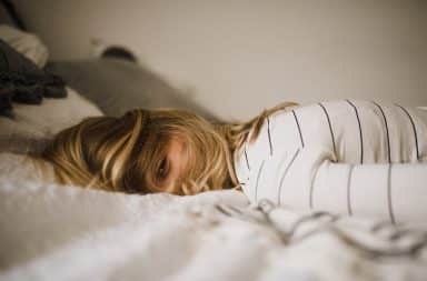 Teen daughter lying in bed