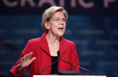 Elizabeth Warren speaking at a podium