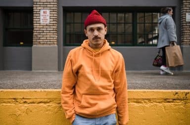 Man wearing an orange hoodie