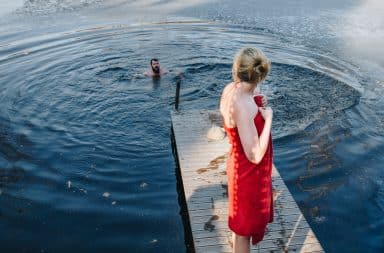 Young couple in the water at a dock